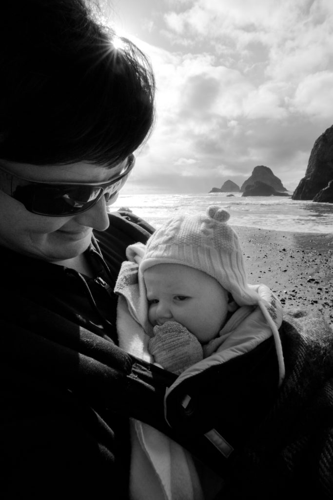 Mother and baby on the Oregon coast, the three rocks of Three Arches Wildlife Refuge in the distance.